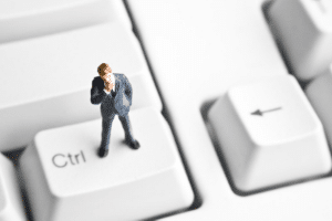 man on keyboard considering ISO 27001 misconceptions