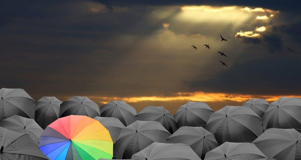 a colourful umbrella representing standing out in the crowd of information security