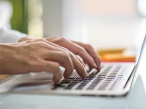 men,hand,typing,on,computer,keyboard,while,working,from,home